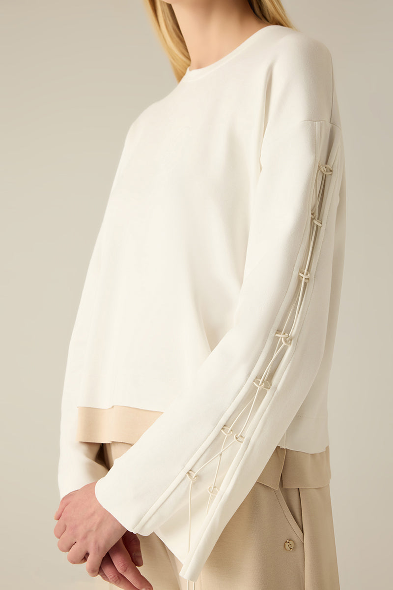 Sweatshirt with sleeve lacing.