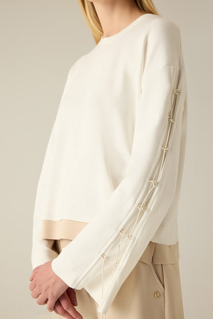 Sweatshirt with sleeve lacing.