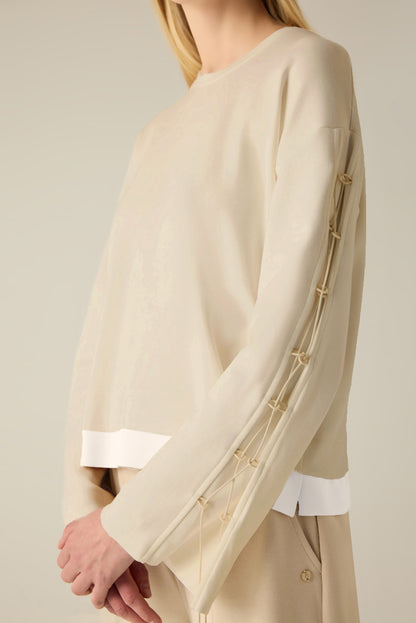 Sweatshirt with sleeve lacing.