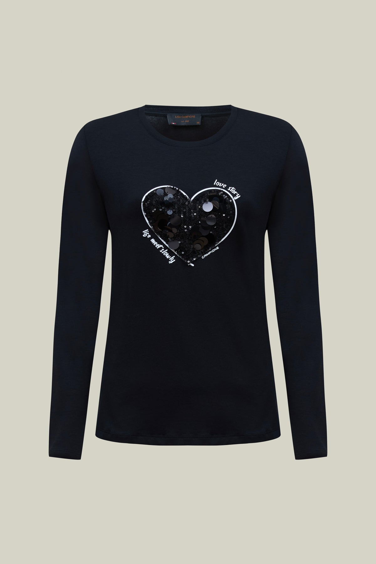 Premium-Langarmshirt in Schwarz mit Rundhals. Edles Herzmotiv aus Pailletten-Mesh, Ton in Ton mit weißen Konturen – stilvoll und einzigartig.
